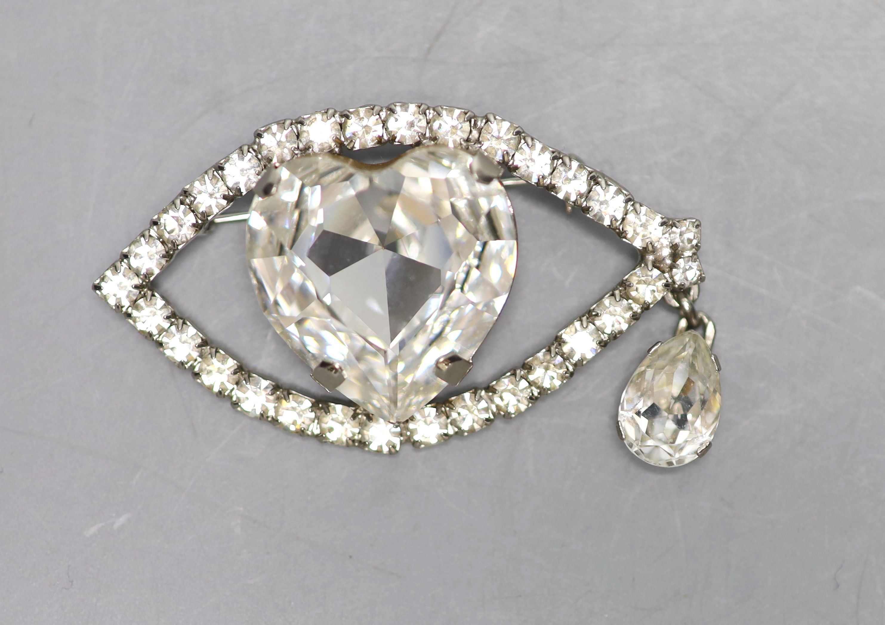 A base metal and white paste set 'eye' drop brooch, width 61mm.